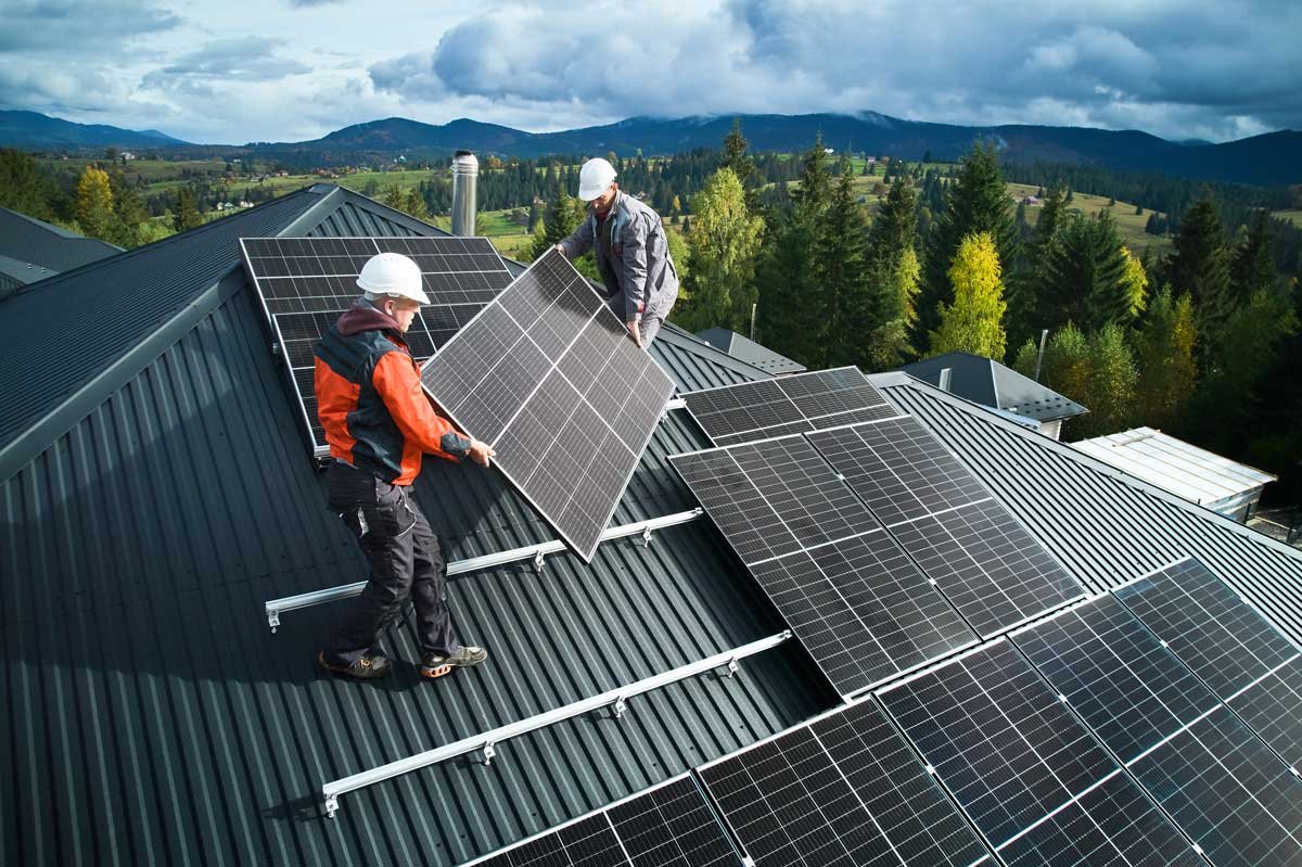 Men installing solar panels on the roof