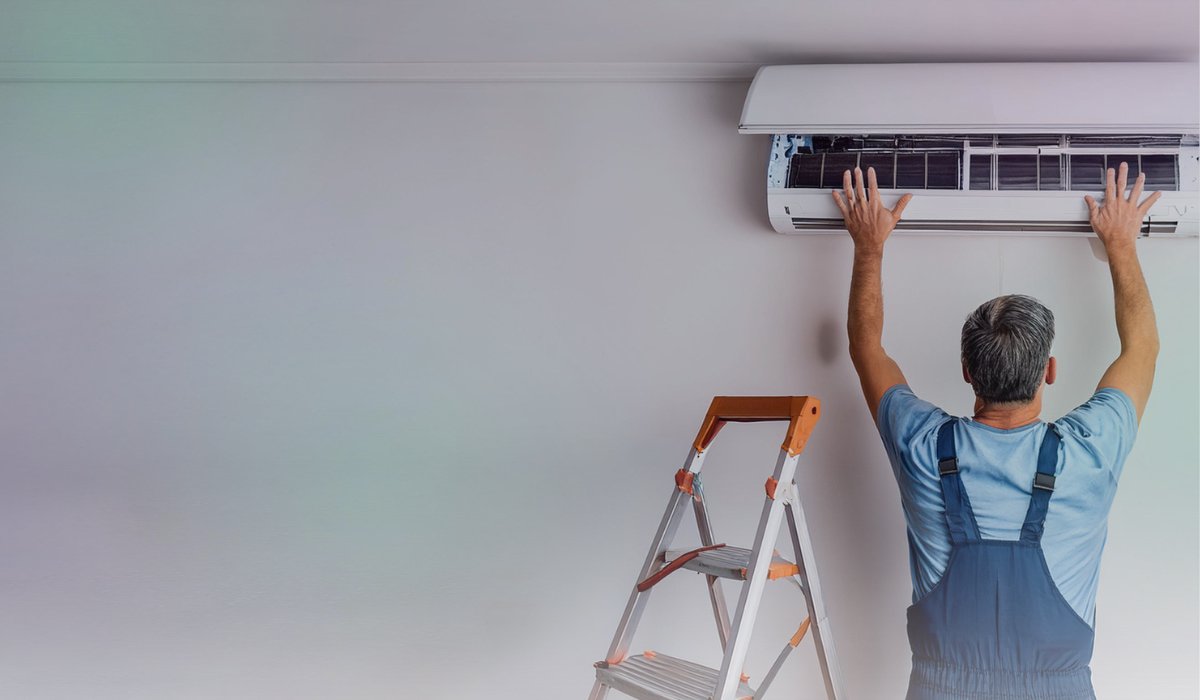 air conditioner installation by a technician in an Australian living room