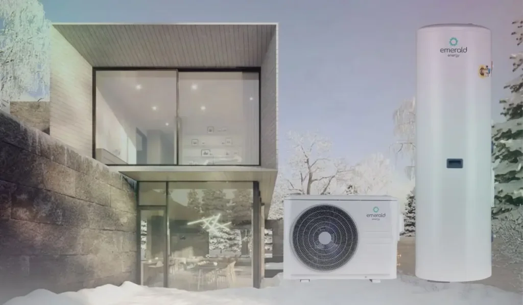 A snowy modern house with a heat pump hot water system installed outdoors, working efficiently in cold weather.