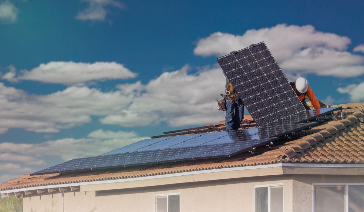 Technicians installing solar panels on the roof of a house in Victoria, Australia.