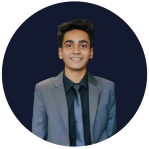 Portrait of a young man in a grey suit with a black shirt and tie, smiling at the camera